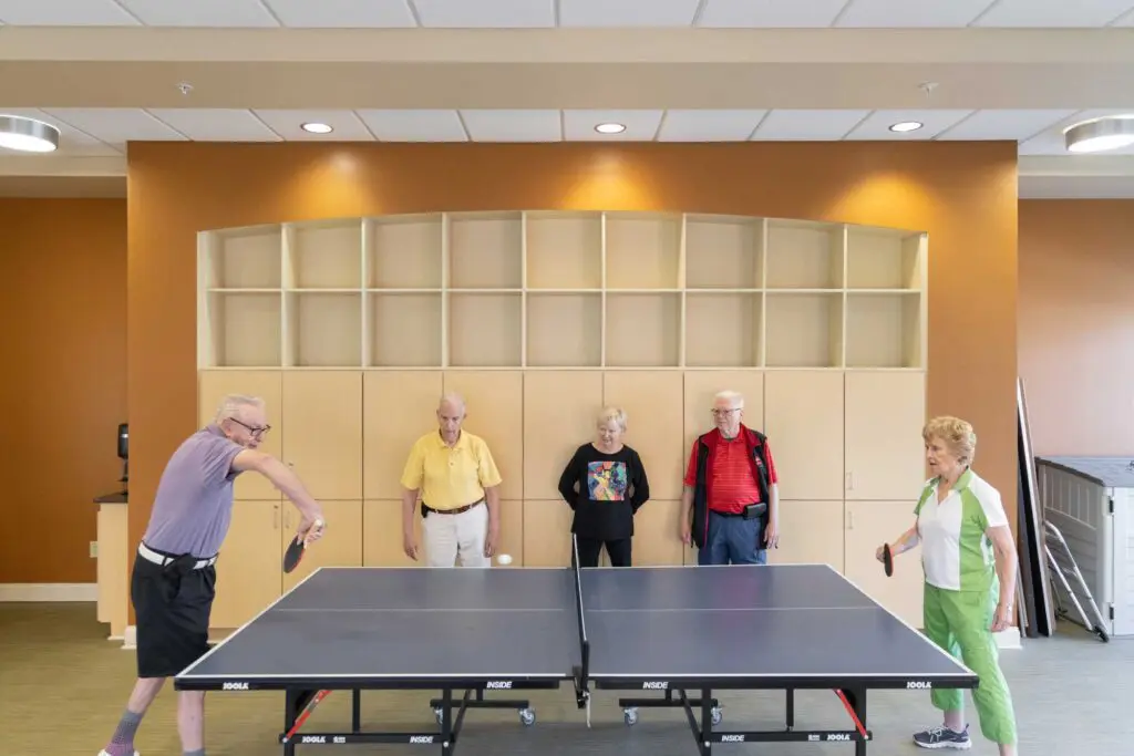 a group of seniors playing ping pong together