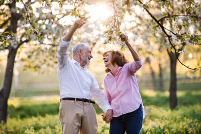 A couple walking in a park.