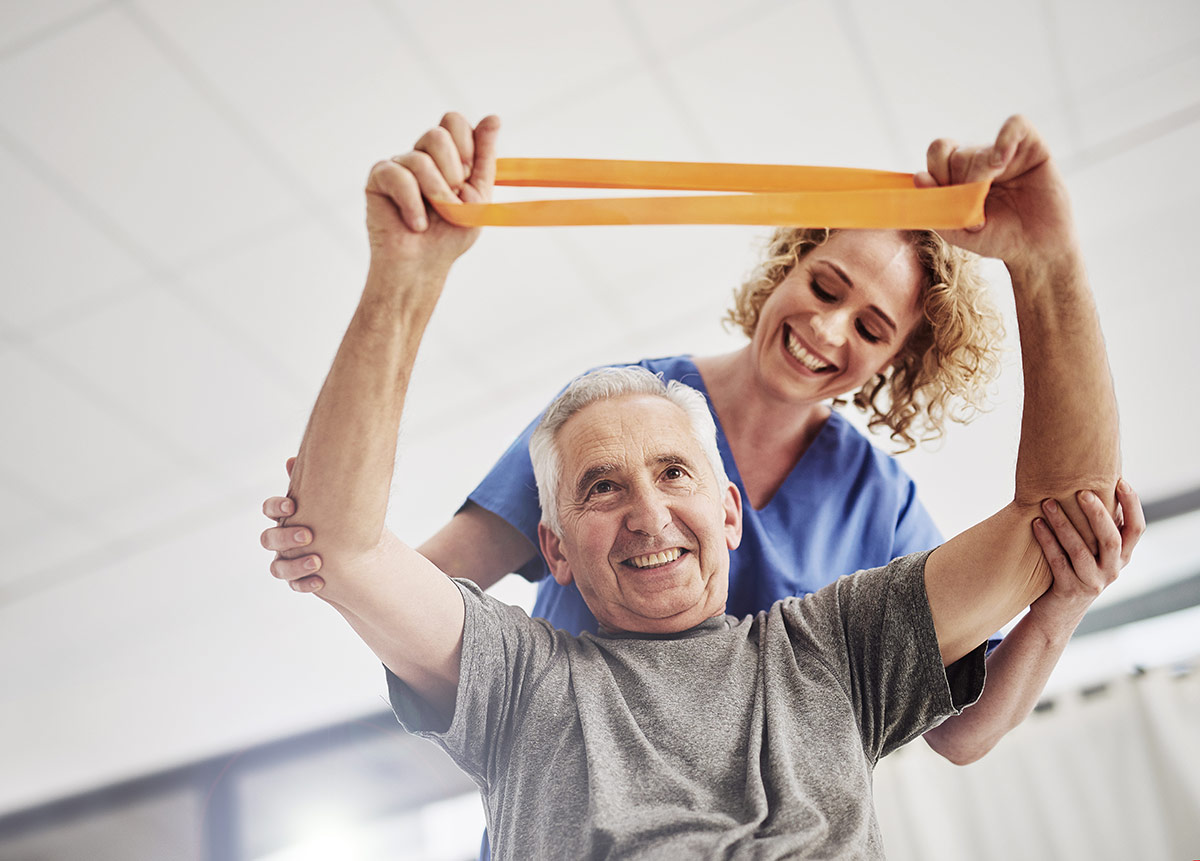 Senior man working with a physical therapist