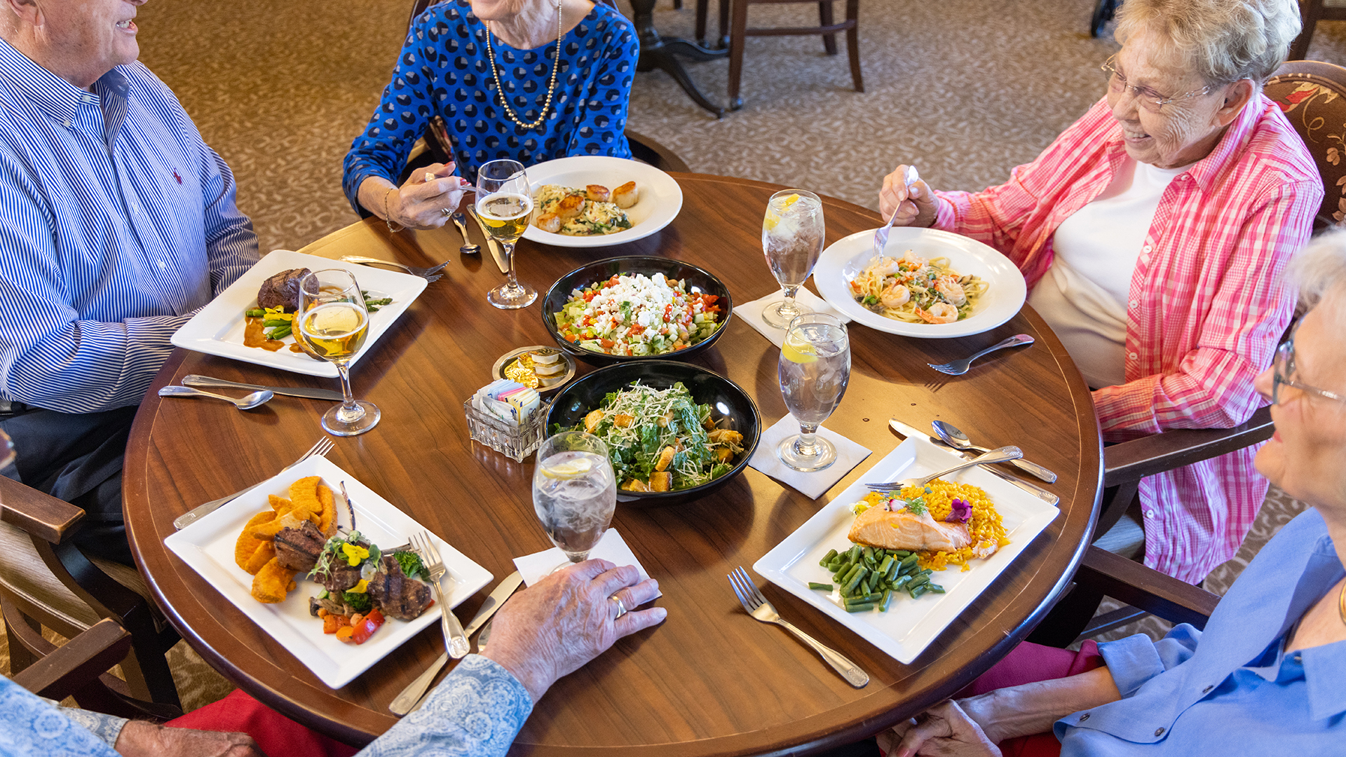 group of seniors enjoying a meal in Whitestone's dining room