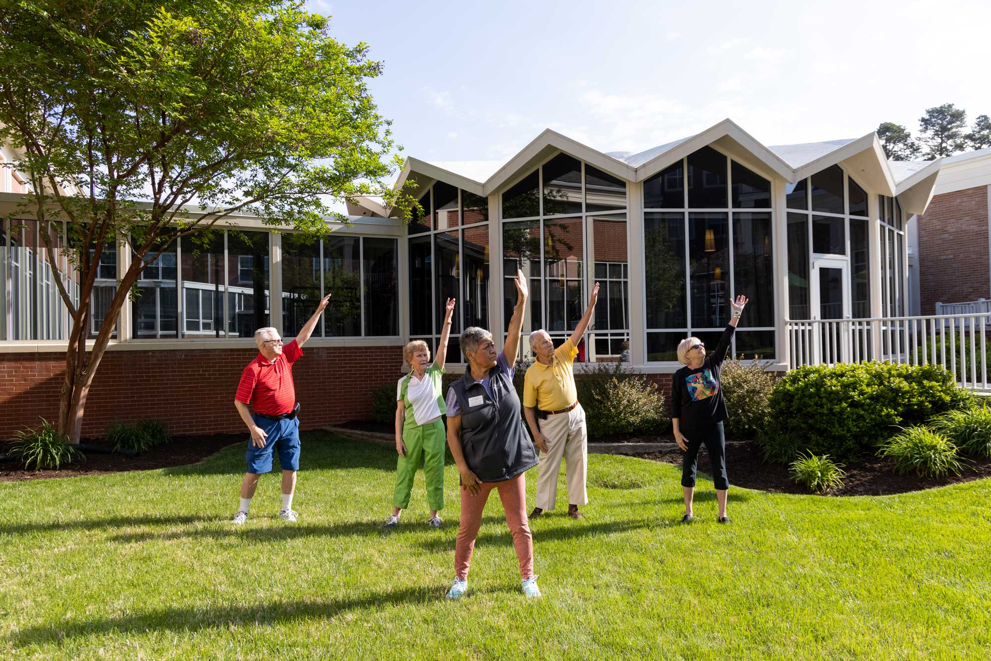 a group of seniors practicing yoga outside