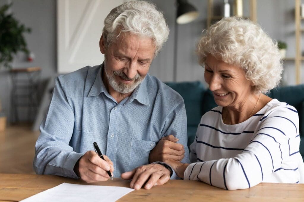 Senior couple signing CCRC contract 