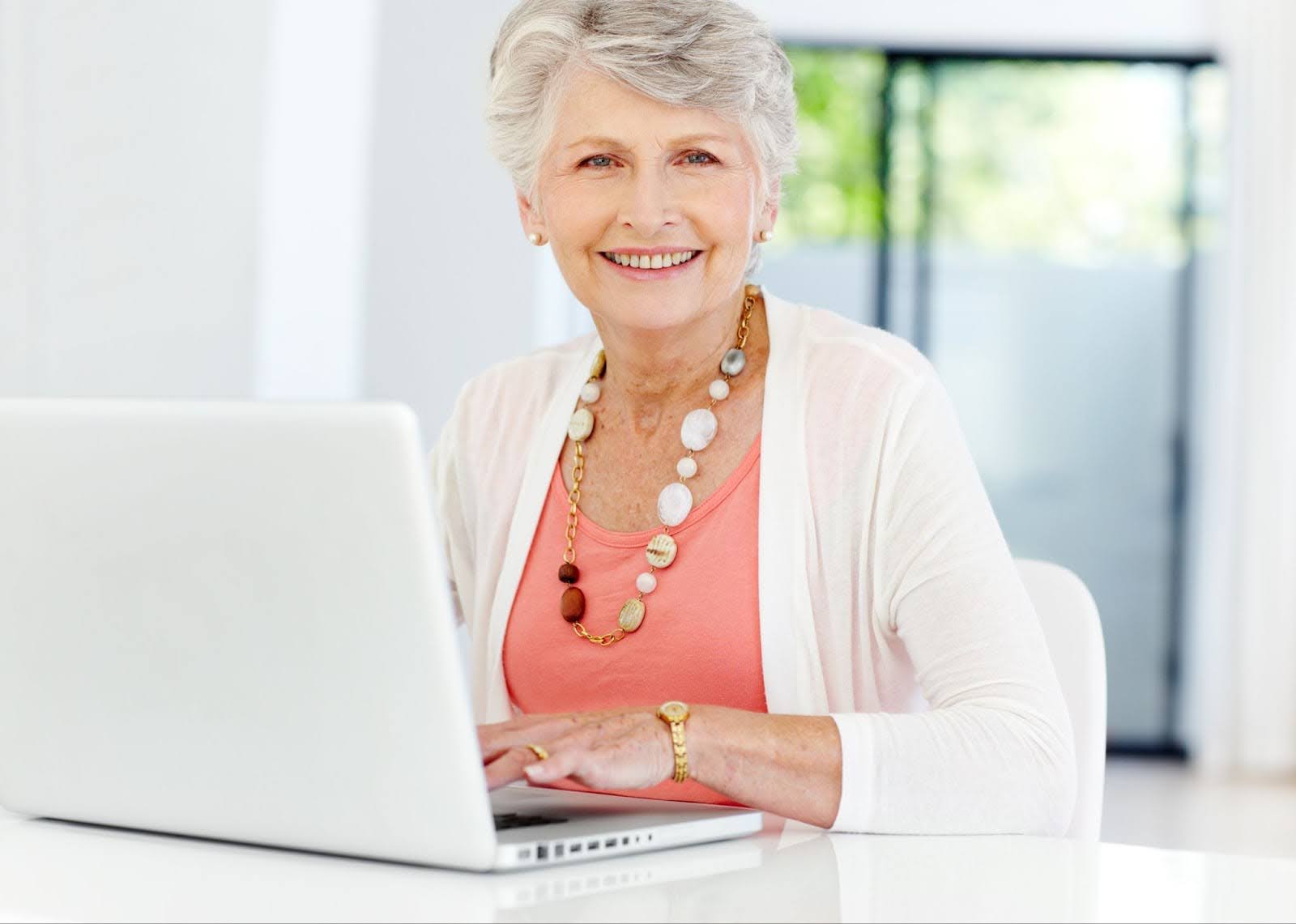 older woman taking online continuing education courses at home