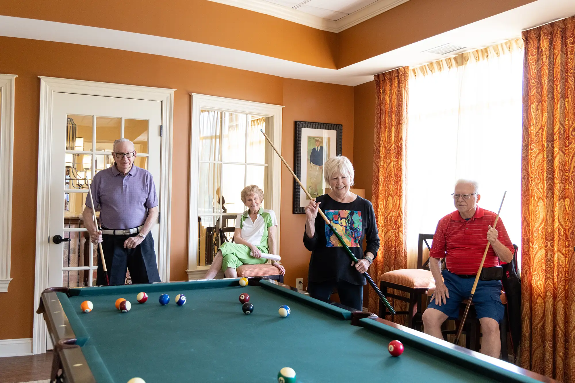 Two senior couples shooting pool at Whitestone