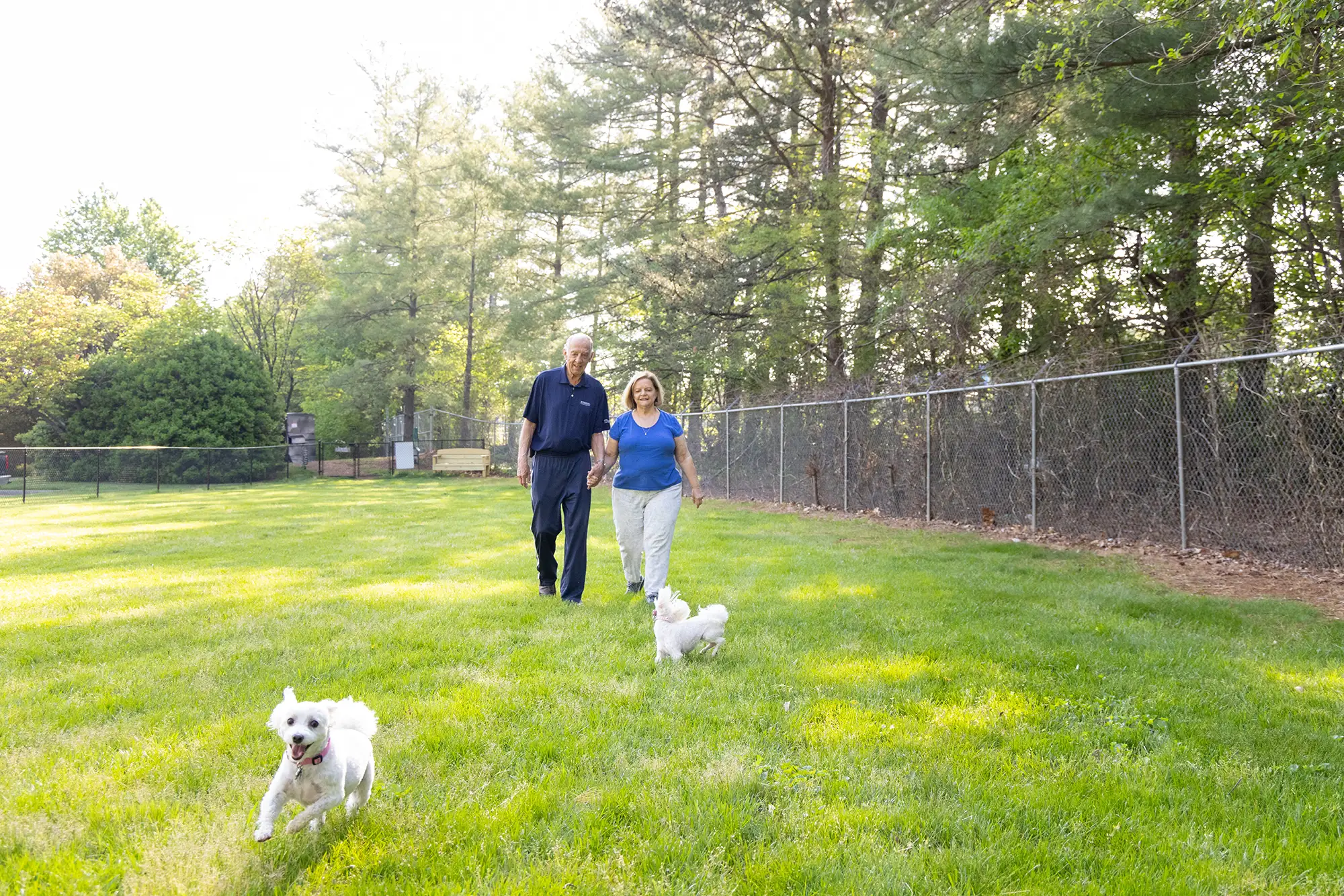 Senior man with his caregiver at the dog park at Whitestone