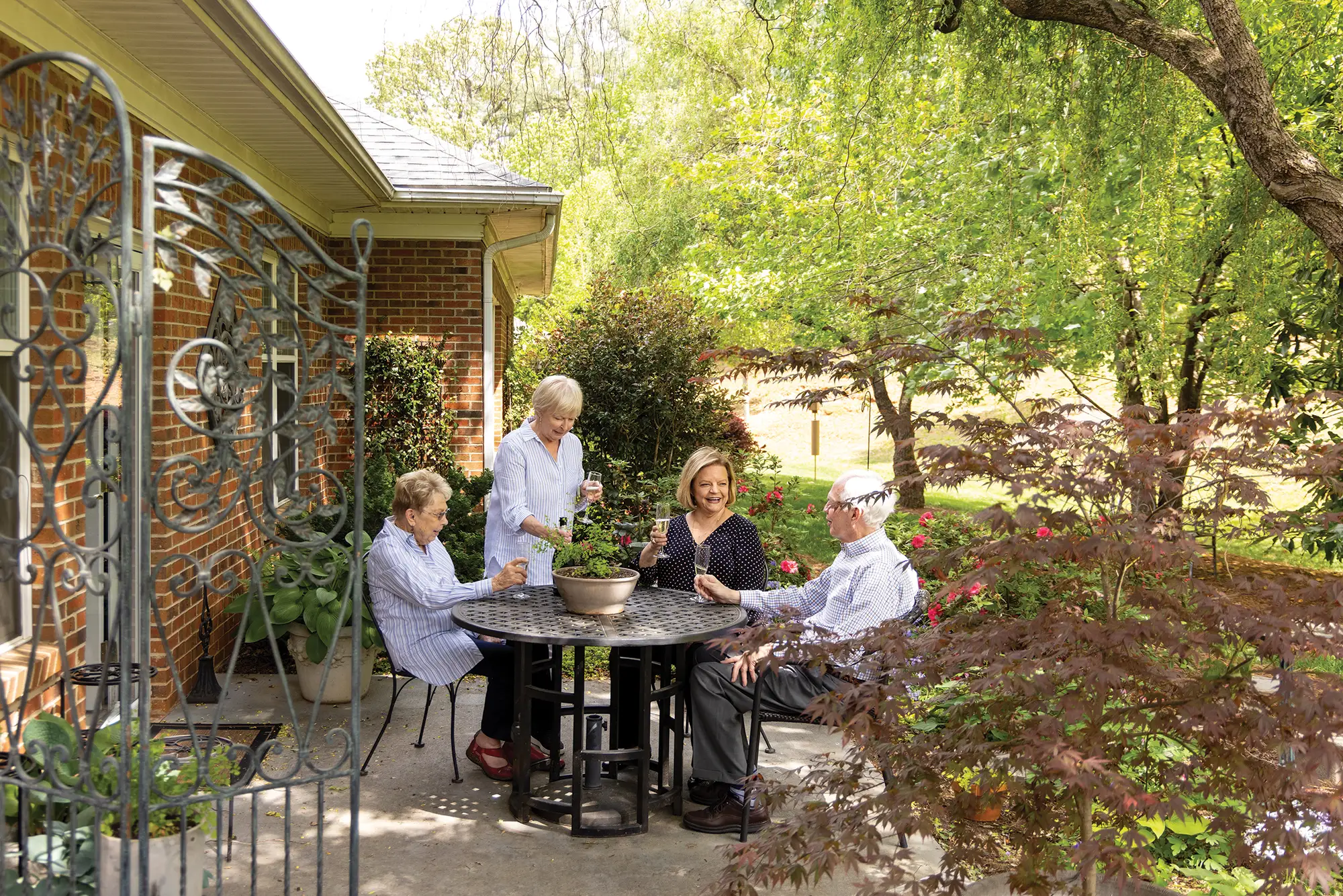 retirement-home-vs-nursing-home-blog-1 seniors having drinks on a patio, retirement home vs. nursing home, Greensboro, NC