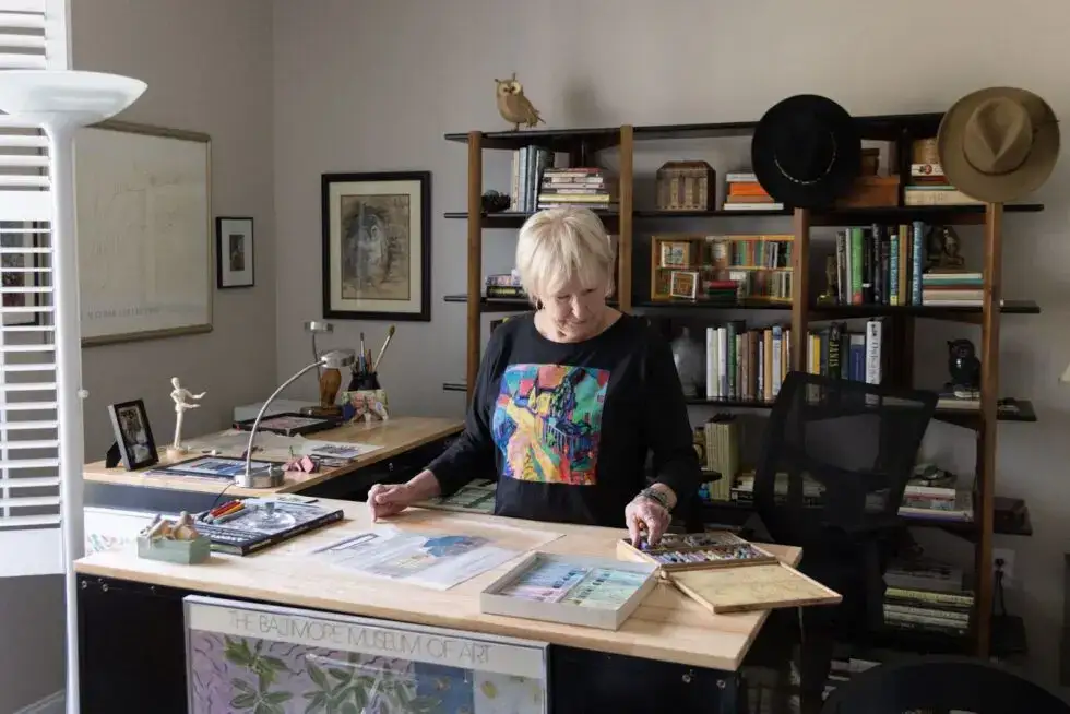 An image of a senior woman working on an art project at WhiteStone, a senior living community.